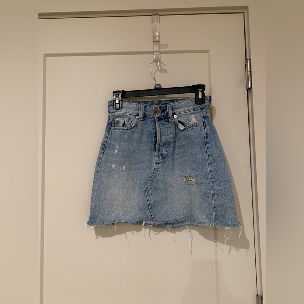 Distressed denim mini skirt